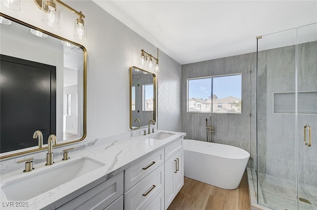 bathroom with vanity, hardwood / wood-style flooring, and independent shower and bath