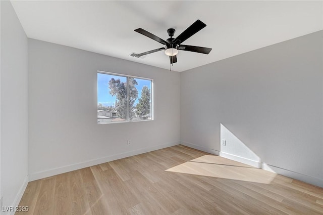 spare room featuring light hardwood / wood-style flooring and ceiling fan