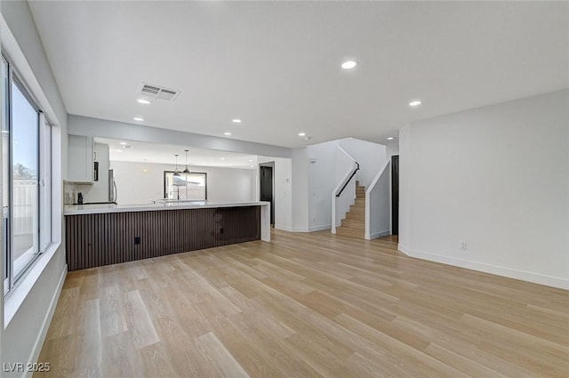 unfurnished living room with light wood-type flooring