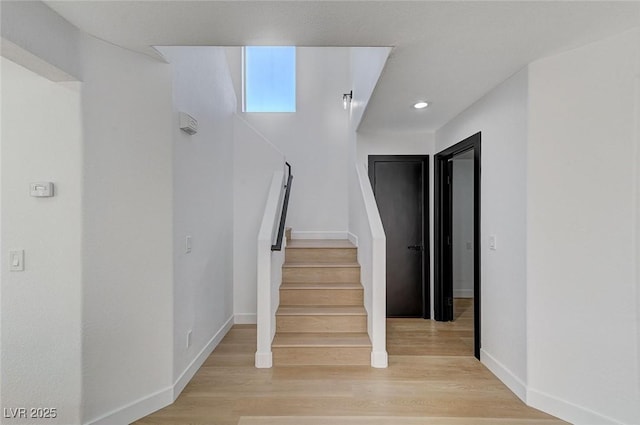 stairs featuring wood-type flooring