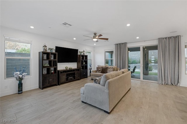 living room featuring ceiling fan and light hardwood / wood-style flooring