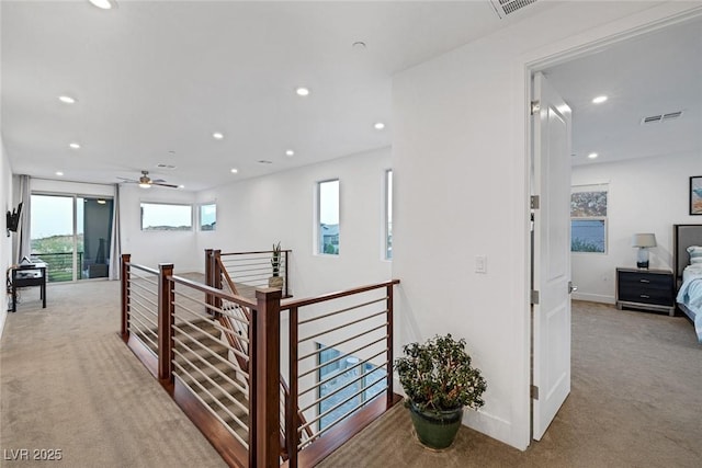 hallway with light colored carpet