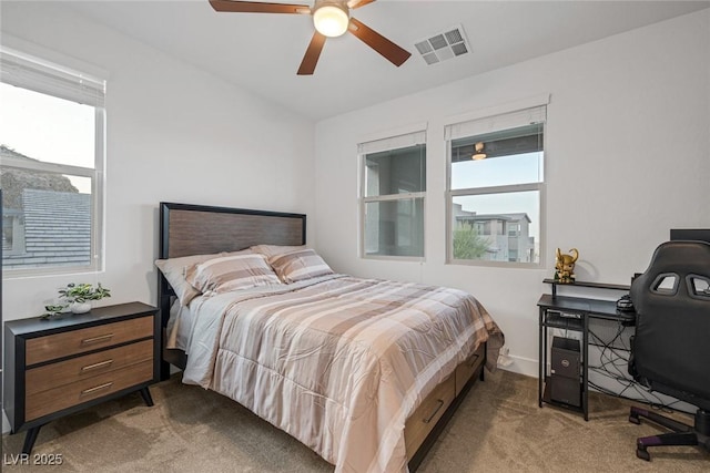 bedroom featuring ceiling fan and dark carpet