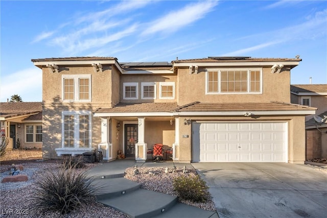 view of front of property with a garage and solar panels