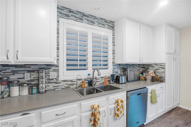 kitchen with sink, dishwasher, white cabinetry, decorative backsplash, and light wood-type flooring