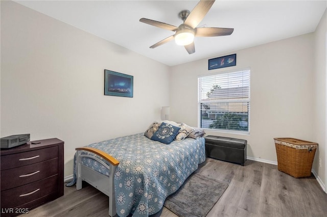 bedroom with light hardwood / wood-style floors and ceiling fan