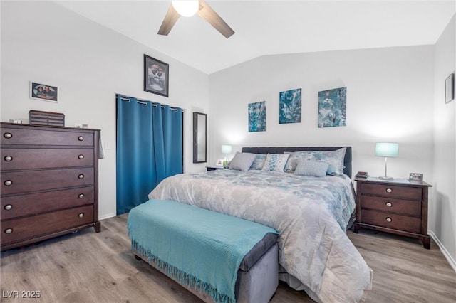 bedroom featuring ceiling fan, lofted ceiling, and light wood-type flooring