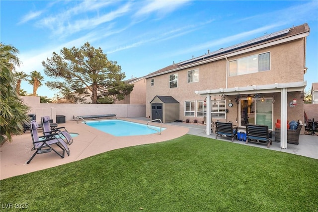 view of pool with a storage shed, a yard, a pergola, and a patio