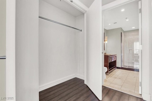 bathroom featuring vanity, toilet, a shower with door, and hardwood / wood-style floors