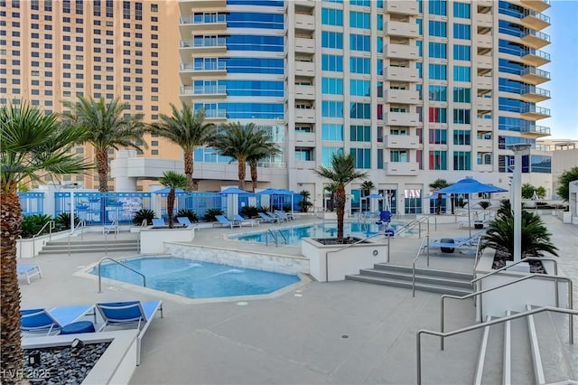 view of pool with a community hot tub and a patio area