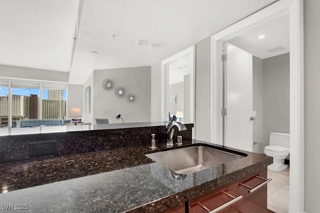 bathroom with sink, tile patterned floors, and toilet