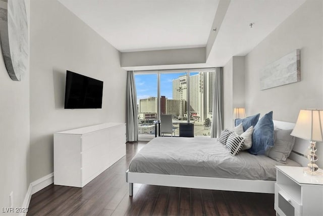 bedroom with dark hardwood / wood-style flooring and access to outside