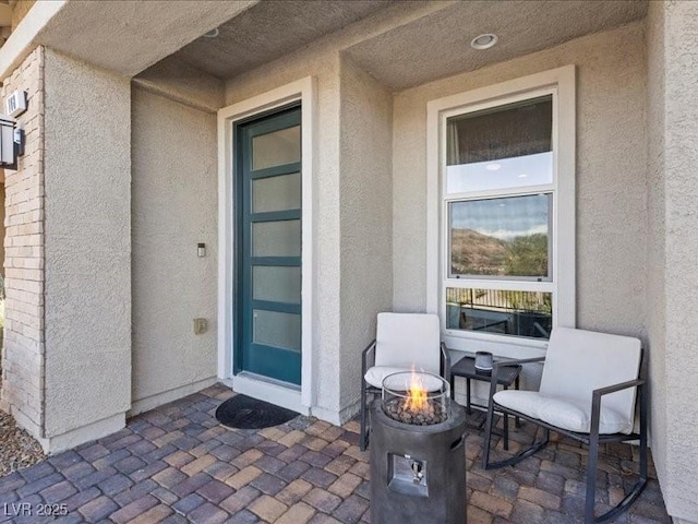 property entrance featuring a patio area