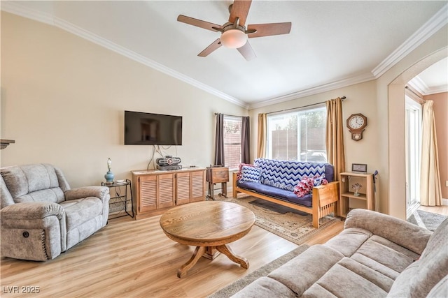 living room with ornamental molding, light hardwood / wood-style floors, and ceiling fan