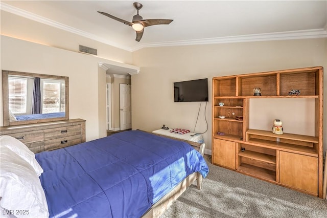 bedroom with crown molding, ceiling fan, and carpet floors