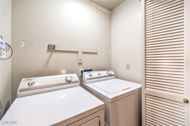 clothes washing area featuring independent washer and dryer