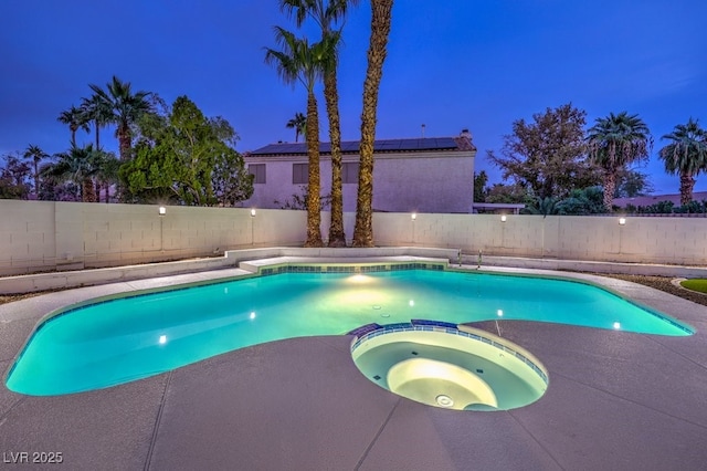 view of pool with a pool with connected hot tub and a fenced backyard