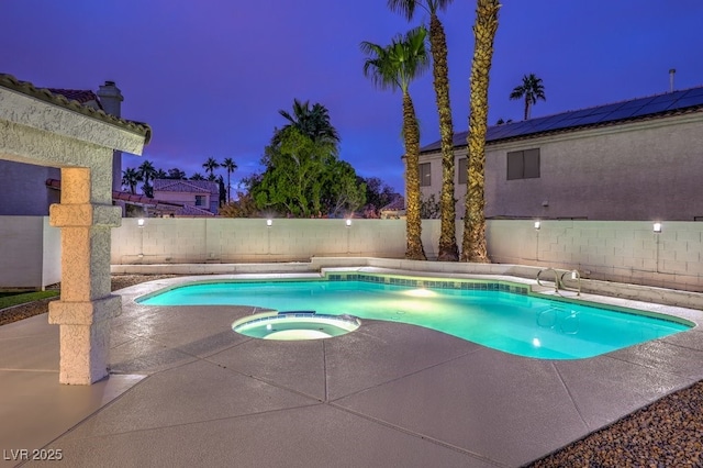 view of pool with a fenced backyard, a pool with connected hot tub, and a patio