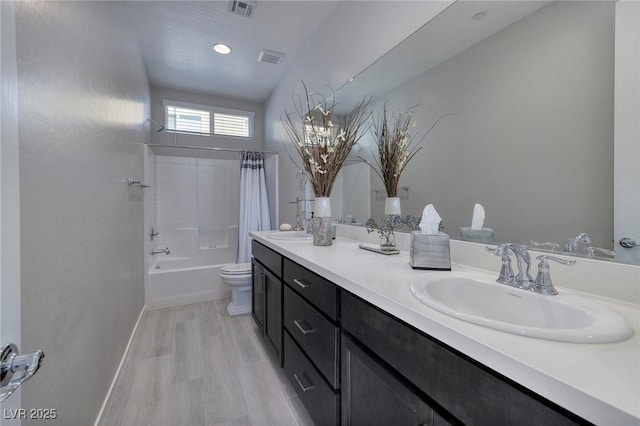 full bathroom with shower / tub combo with curtain, vanity, wood-type flooring, and toilet