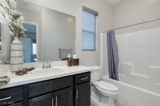 full bathroom with shower / tub combo with curtain, vanity, and toilet