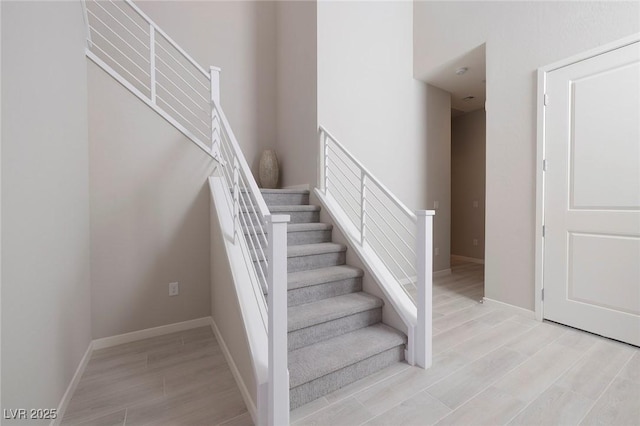 staircase with wood-type flooring