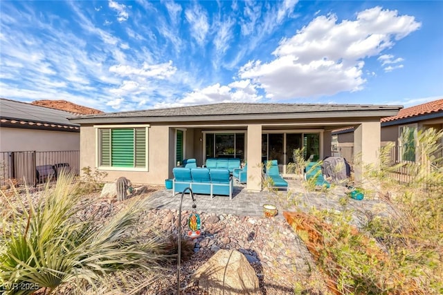 back of property featuring outdoor lounge area and a patio area