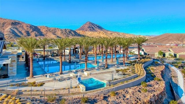 view of swimming pool with a mountain view