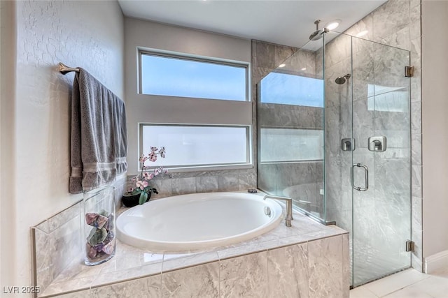 bathroom with tile patterned floors and shower with separate bathtub