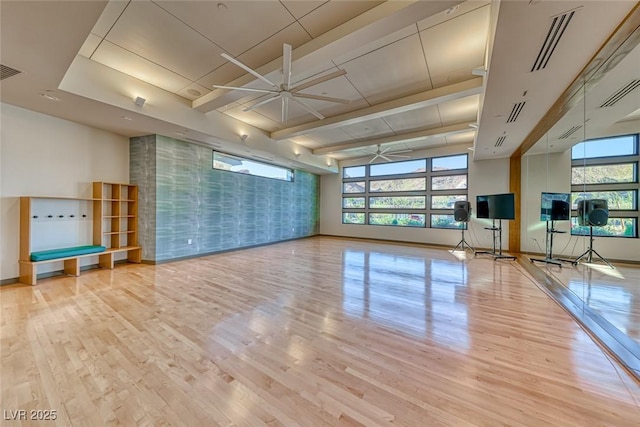 workout area featuring ceiling fan and light hardwood / wood-style flooring