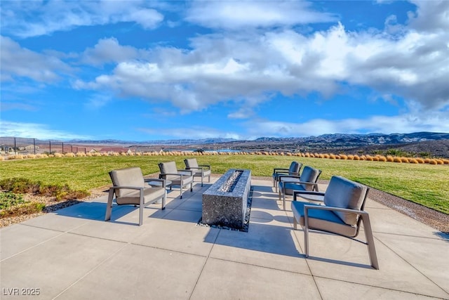 view of patio featuring a mountain view and a fire pit