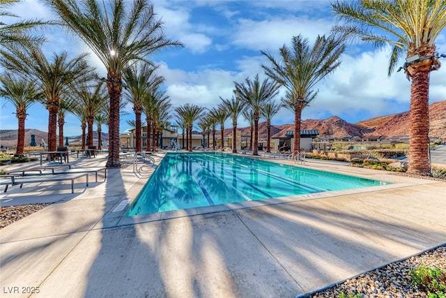 view of pool featuring a mountain view and a patio