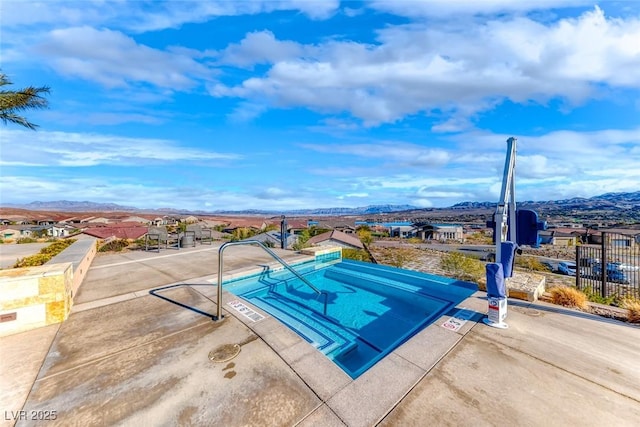 view of swimming pool featuring a mountain view and a patio area