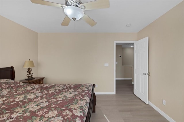 bedroom with ceiling fan and light hardwood / wood-style flooring