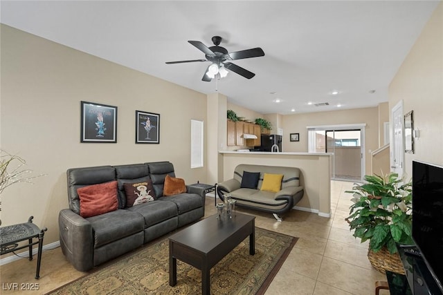 living room featuring light tile patterned floors and ceiling fan