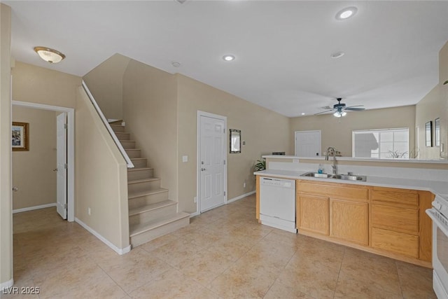 kitchen featuring light brown cabinetry, sink, light tile patterned floors, ceiling fan, and white appliances