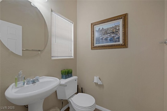 bathroom featuring sink and toilet