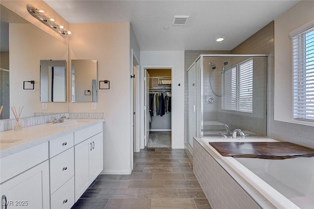 bathroom featuring vanity and plus walk in shower