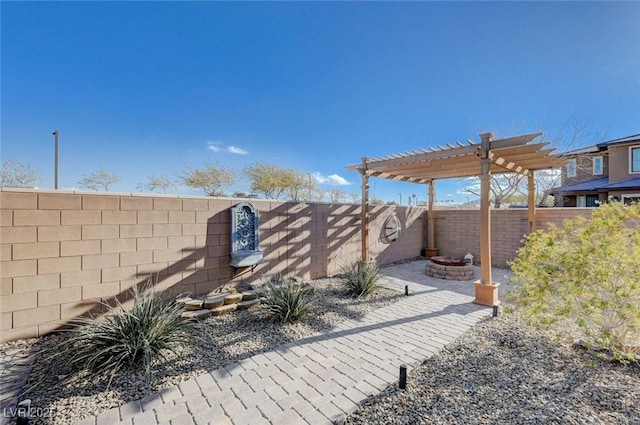 view of yard featuring a fire pit, a patio area, and a pergola