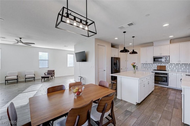 dining room featuring wood-type flooring and ceiling fan