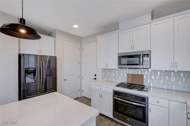 kitchen with white cabinetry, decorative light fixtures, and appliances with stainless steel finishes