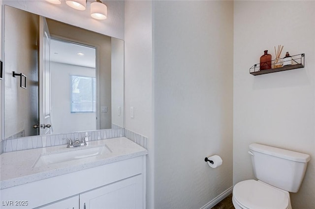 bathroom featuring vanity and toilet