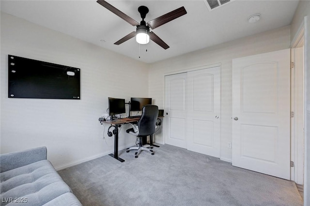 carpeted office featuring ceiling fan