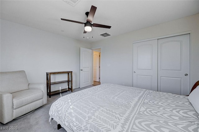 bedroom featuring ceiling fan, light colored carpet, and a closet