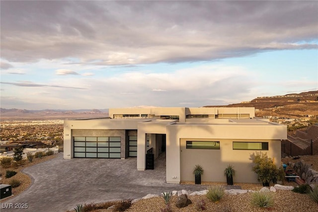 pueblo-style home featuring a garage