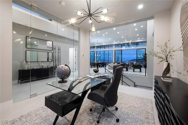 home office featuring expansive windows and a notable chandelier