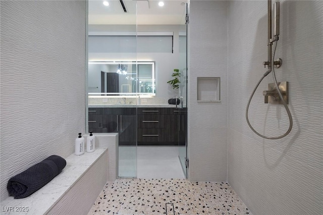 bathroom with tile patterned floors, vanity, and a shower