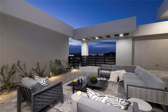 patio terrace at dusk featuring outdoor lounge area