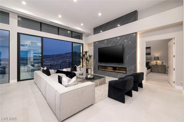 living room featuring a premium fireplace and light tile patterned floors