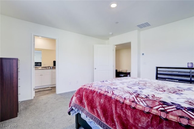 carpeted bedroom with ensuite bath