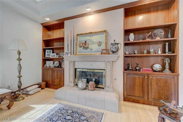 living room featuring built in features and light hardwood / wood-style floors